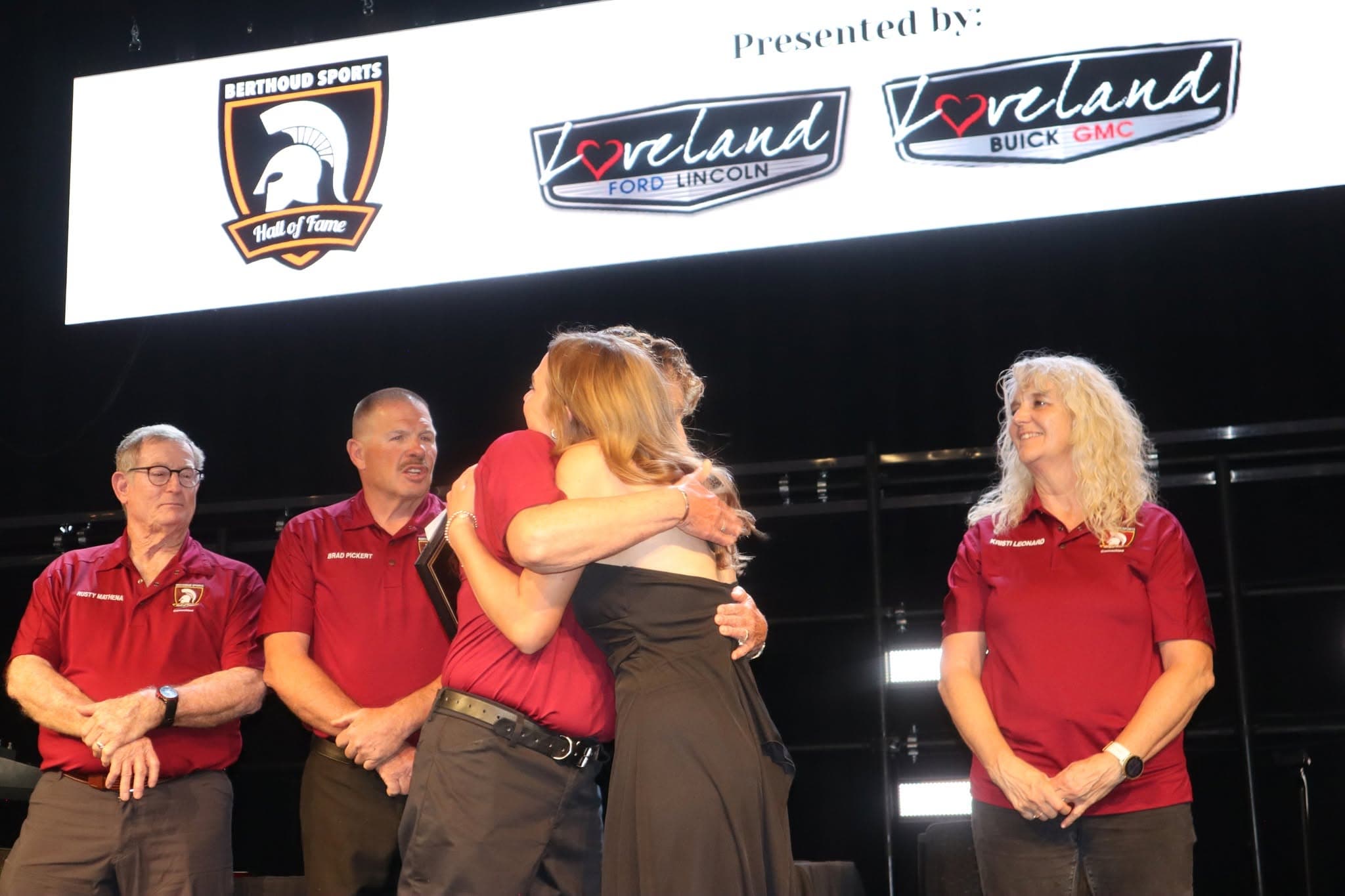 Award ceremony embrace during Hall of Fame recognition