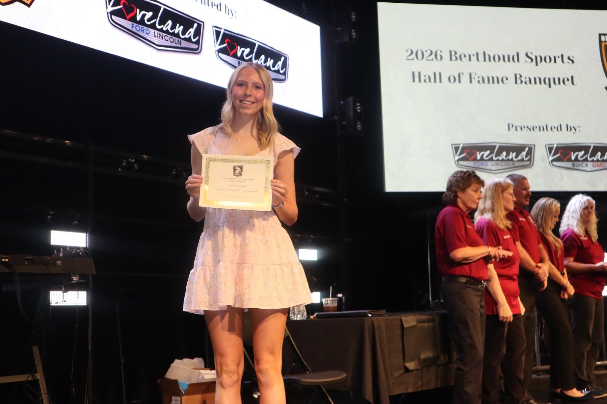 Hall of Fame inductee receives framed award at the annual banquet